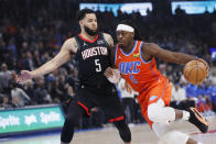 Oklahoma City Thunder guard Luguentz Dort, right, drives against Houston Rockets guard Fred VanVleet during the first half of an NBA basketball game Wednesday, March 27, 2024, in Oklahoma City. (AP Photo/Nate Billings)