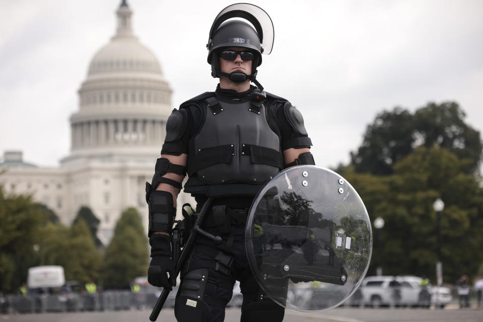 A police officer in riot gear monitors the scene which failed to really materialise. Source: Getty