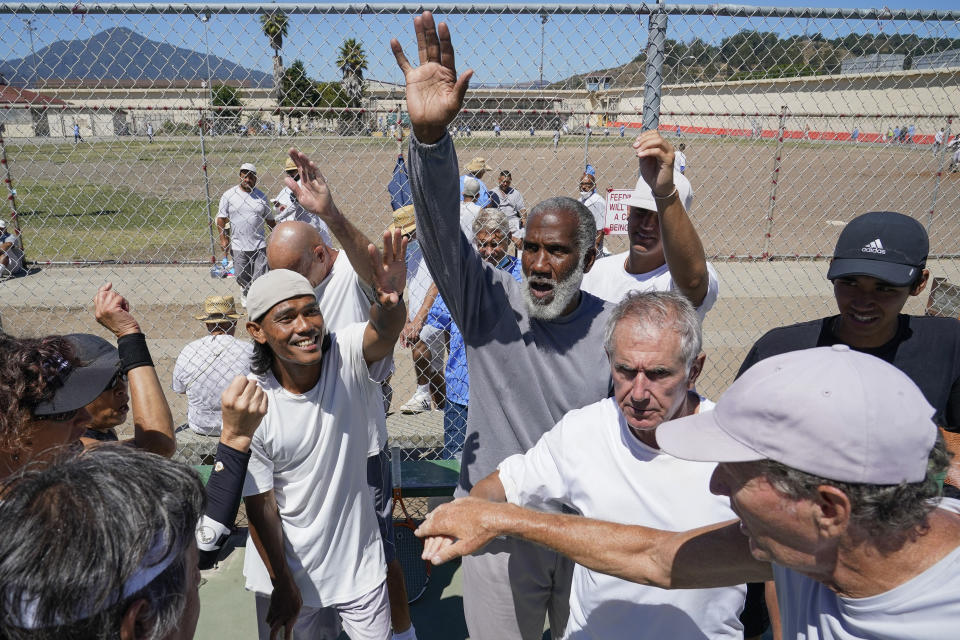 San Quentin State Prison inmates and a group of visiting players break a huddle after playing tennis together in San Quentin, Calif., Saturday, Aug. 13, 2022. (AP Photo/Godofredo A. Vásquez)
