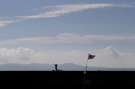 A man fishes near Eco Park, an area once polluted by mercury-containing wastewater and later turned into a massive landfill, in Minamata, Kumamoto Prefecture, Japan, September 12, 2017. REUTERS/Kim Kyung-Hoon