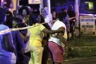 FILE - Family members react as they watch investigators at the scene of a fatal collision on Roosevelt Boulevard in Philadelphia, on July 16, 2013. Samara Banks, along with three of her four children, Saa'deem Griffin, Saa'mir Williams, and Saa'sean Williams were struck by a car and killed in 2013 while crossing the Boulevard. (AP Photo/ Joseph Kaczmarek, File)