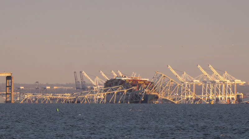 Parts of the Francis Scott Key Bridge remain after a container ship collided with a support Tuesday, March 26, 2024 in Baltimore. The major bridge in Baltimore snapped and collapsed after a container ship rammed into it early Tuesday, and several vehicles fell into the river below. Rescuers were searching for multiple people in the water. (Kaitlin Newman/The Baltimore Banner via AP)