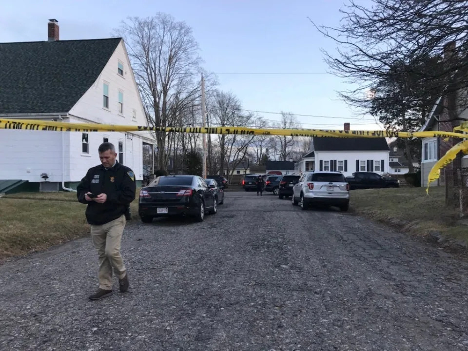 Brockton and State police have a house surrounded on Mellen Street in Brockton on the afternoon of Tuesday, Jan. 31, 2023, hours after a fatal shooting at a nearby Dollar Tree store on North Montello Street.