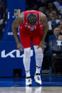 Philadelphia 76ers' Joel Embiid grabs his left knee after the basket during the first half of an NBA basketball game against the Orlando Magic, Friday, April 12, 2024, in Philadelphia. (AP Photo/Chris Szagola)