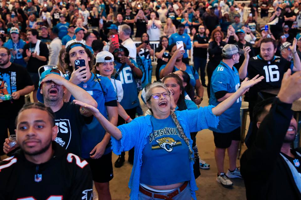 Lisa Miller, center, reacts to the 27th pick, Anton Harrison, during an NFL Draft watch party Thursday, April 27, 2023 at TIAA Bank Field’s Daily’s Place in Jacksonville, Fla. The Jacksonville Jaguars selected, with the 27th pick, offensive tackle Anton Harrison from Oklahoma. [Corey Perrine/Florida Times-Union]