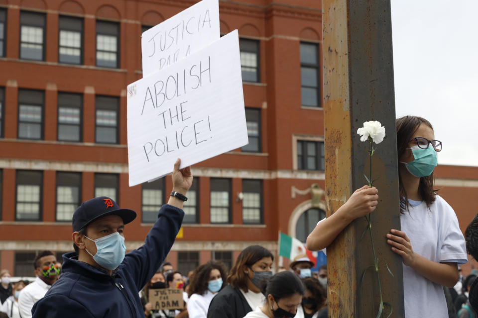 People attend a peace walk honoring the life of police shooting victim 13-year-old Adam Toledo, Sunday, April 18, 2021, in Chicago's Little Village neighborhood. (AP Photo/Shafkat Anowar)