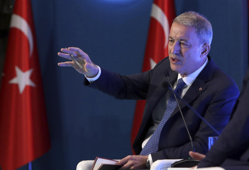 Turkey's Defense Minister Hulusi Akar addresses a meeting of his country's ambassadors, in Ankara, Turkey, Wednesday, Aug. 7, 2019. Akar says his country would like to establish a safe zone in northeast Syria jointly with the United States but would act alone if necessary.(Turkish Defence Ministry via AP, Pool)