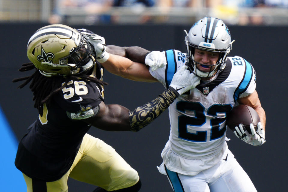 Carolina Panthers running back Christian McCaffrey pushes away from New Orleans Saints outside linebacker Demario Davis during the second half of an NFL football game Sunday, Sept. 19, 2021, in Charlotte, N.C. (AP Photo/Jacob Kupferman)