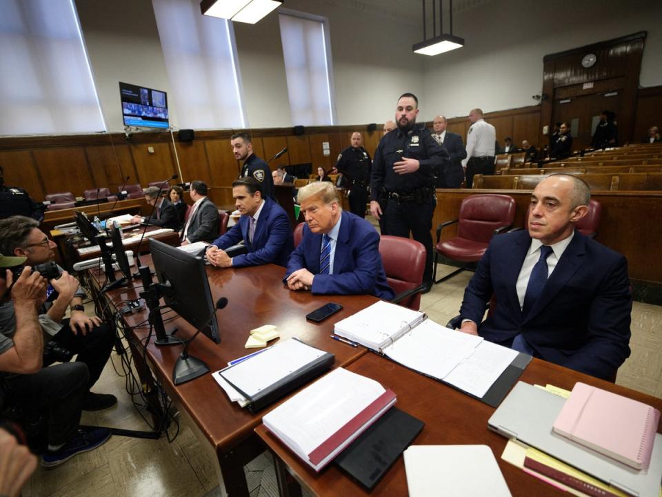 Lawyers Todd Blanche and Emil Bove surround Trump in the courtroom with attorneys on the trial’s second day (via REUTERS)