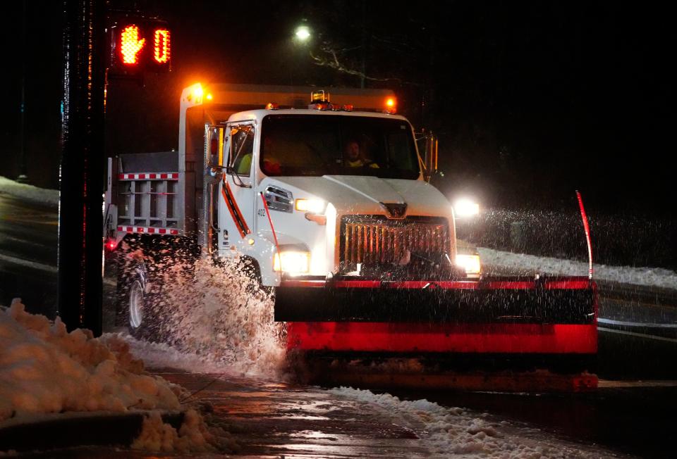 A salt truck clears the edge of Galbraith Road in Cincinnati, near Kenwood Mall, as it drops salt on the roadway in January 2023.