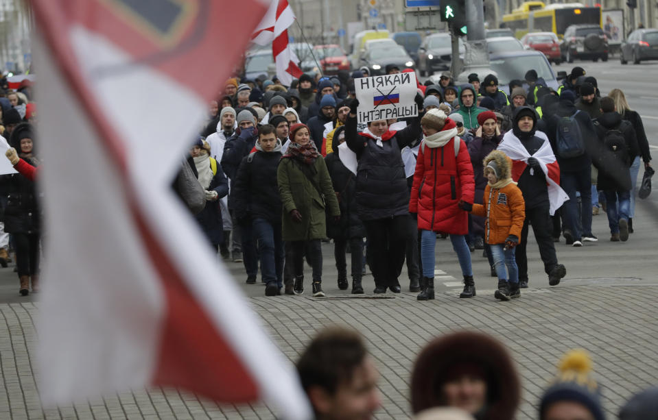 Protesters attend the procession in downtown Minsk, Belarus, Saturday, Dec. 7, 2019. More than 1,000 opposition demonstrators are rallying in Belarus to protest closer integration with Russia. Saturday's protest in the Belarusian capital comes as Belarusian President Alexander Lukashenko is holding talks with Russian President Vladimir Putin in Sochi on Russia's Black Sea coast. (AP Photo/Sergei Grits)