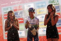 Orica GreenEdge rider Esteban Chaves of Colombia sprays champagne as he celebrates on the podium after winning the 158.7 km (98.6 miles) 2nd stage of the Vuelta Tour of Spain cycling race from Alhaurin de la Torre to Caminito del Rey, in Ardales, southern Spain, August 23, 2015. REUTERS/Jon Nazca