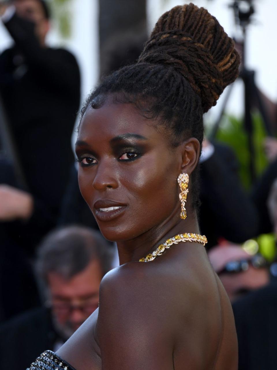 Jodie Turner-Smith with a dark smoky eye and a high bun 