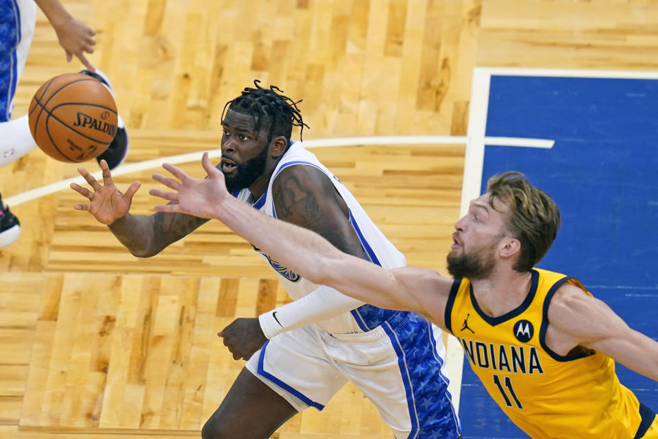 Orlando Magic forward James Ennis III, left, and Indiana Pacers forward Domantas Sabonis (11) go after a loose ball during the first half of an NBA basketball game Friday, April 9, 2021, in Orlando, Fla. (AP Photo/John Raoux)