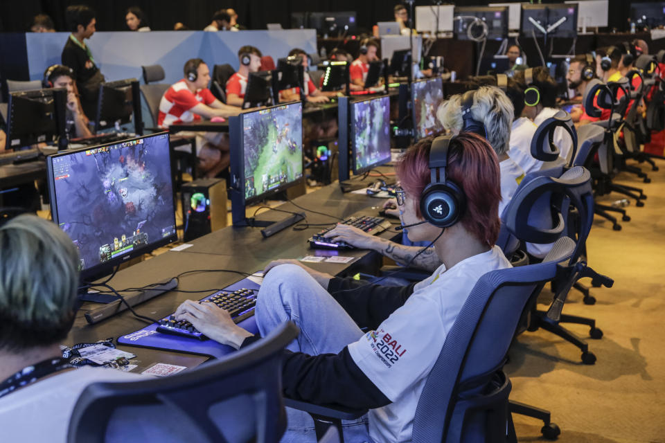 BALI, INDONESIA - DECEMBER 03: Gamers compete during the 14th World Esports Championship 2022 in Nusa Dua, Bali, Indonesia on December 3, 2022. The International Esports Federation (IESF) holds 10 days events with six online games being competed which attended by 600 athletes from 105 countries and will be consider as the biggest international esports tournament by Guinness Book World of Records. The event also expected to promote sports tourism in Bali resort island after the Covid-19 pandemic. (Photo by Johannes P. Christo/Anadolu Agency via Getty Images)