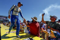Christopher Bell greets fans before a NASCAR Cup Series auto race Sunday, Oct. 2, 2022, in Talladega, Ala. (AP Photo/Butch Dill)