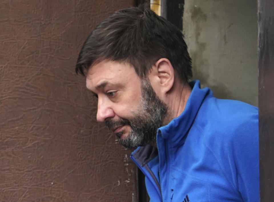 Kirill Vyshinskiy, the head of the Ukrainian office of Russia's RIA Novosti news agency in Ukraine, is escorted from a court room in Kiev, Ukraine, Monday, July 15, 2019. The Ukrainian Prosecutor General's office said that it is likely that a Russian journalist kept in detention in Ukraine is likely to be released. (AP Photo/Evgeniy Maloletka)