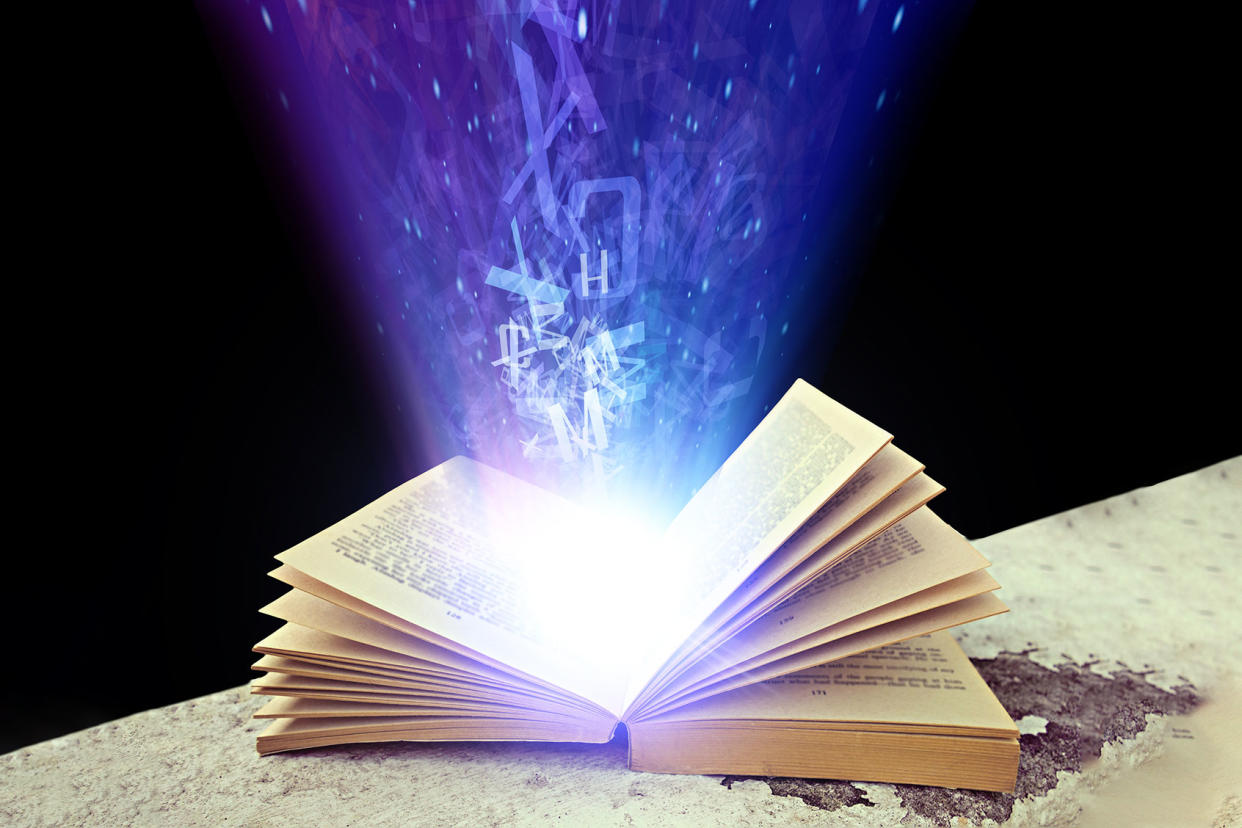 Abstract photo of a open book with light and letters Getty Images/fotojog