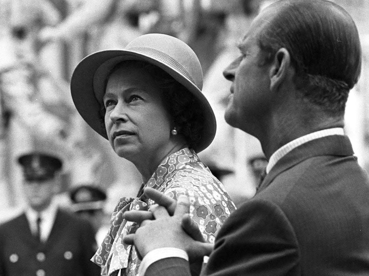 Queen Elizabeth II and Prince Philip listen to welcome speech by Premier Alex B. Campbell in Prince Edward Island on July 1, 1973. (The Canadian Press - image credit)