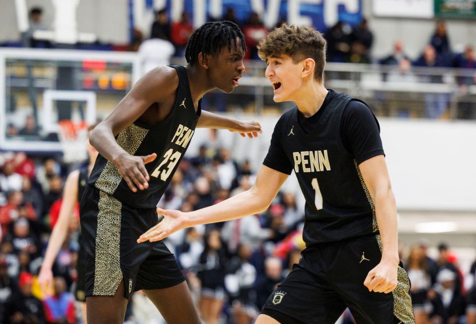 Penn's Josh Gatete (23) and Joey Garwood (1) react to made basket during the Penn-Hammond Central high school 4A Semi-State Semi-Final basketball game on Saturday, March 18, 2023, at Michigan City High School in Michigan City, Indiana.
