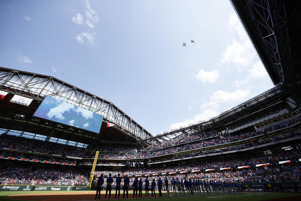 F-16 fighter jets perform a flyover during the National Anthem before the Texas Rangers take on the Toronto Blue Jays on Opening Day at Globe Life Field on Monday. / Credit: / Getty Images