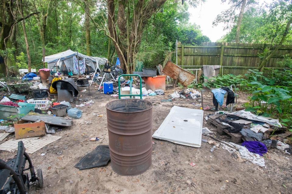 Homeless camps off Murphy Lane in Brent on Wednesday, July 19, 2023. The owner of one of the properties, Collier Merrill, said he will continue efforts to clean up the property, but grant time for people camping at the property site to find somewhere else to go.