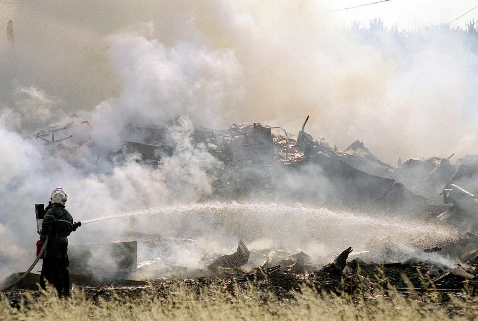 FILE - In this July 25, 2000, file photo, a firefighter sprays water on the debris of an Air France Concorde plane after it crashed into a hotel shortly after takeoff in Gonesse, France, outside of Paris. A French appeals court is expected to decide on Thursday, Nov. 29, 2012, whether to uphold a manslaughter conviction against Continental Airlines for the crash over a decade ago of an Air France Concorde that killed 113 people. Continental Airlines, Inc. and one of its mechanics were convicted in 2010.(AP Photo/Ministry of Interior/Civil Security, Joachim Bertrand, Pool, File)