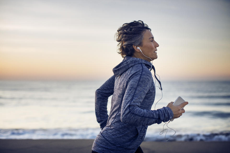 Woman exercising outside, which can help you feel more awake. (Getty Images)