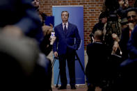 Nigel Farage the leader of the Brexit Party stands at the back of the room as he waits to walk down to the podium to speak during an election press conference in London, Tuesday, Dec. 10, 2019. Britain goes to the polls on Dec. 12. (AP Photo/Matt Dunham)