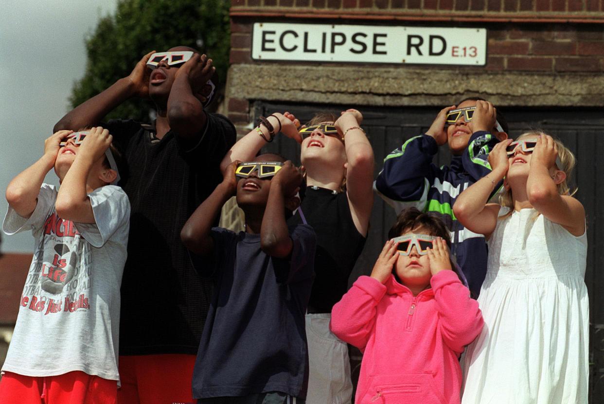 1999: Children view an eclipse from Eclipse Road in London. 