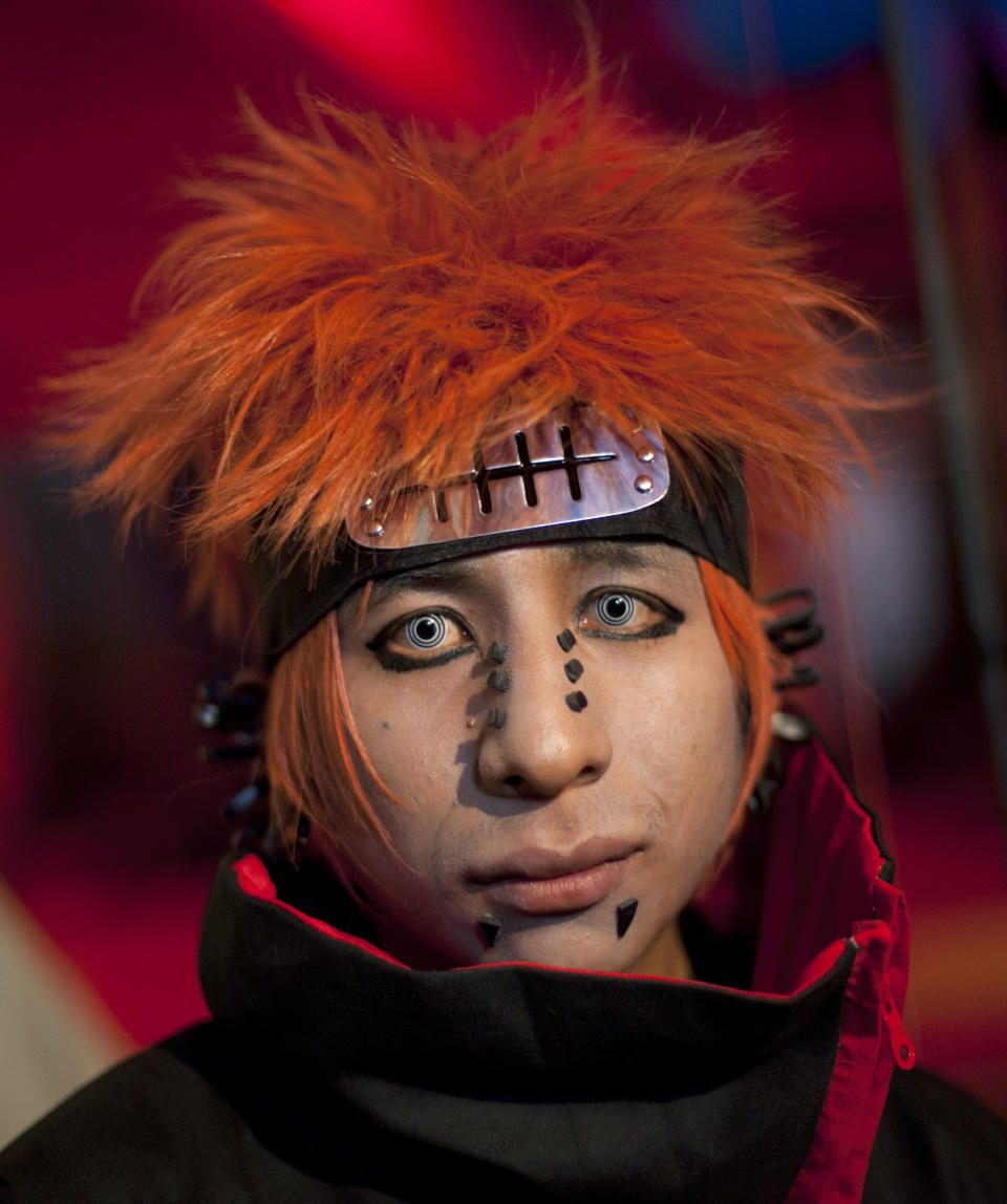 In this May 25, 2013 photo, Gino, who did not give his last name, wears a costume that mimics the character "Pain" from a Japanese comic, during a K-pop music party held at a school that was rented for the occasion in Lima, Peru. (AP Photo/Martin Mejia)