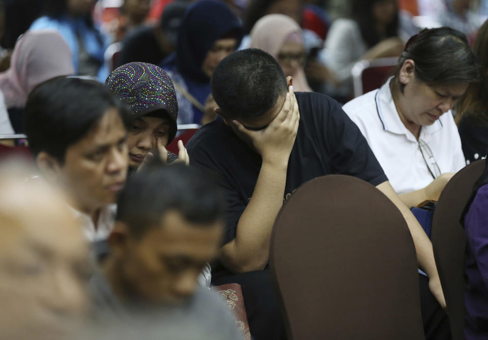 Relatives of victims in the Lion Air jet that crashed into the Java Sea react during a press conference in Jakarta, Indonesia, Monday, Nov. 5, 2018. Distraught and angry relatives of those killed when a Lion Air jet crashed last week have confronted the airline's executives during a meeting arranged by Indonesian officials. (AP Photo/Achmad Ibrahim)