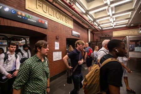 Commuters are seen inside the Fulton Street subway station after police investigated two suspicious packages in Manhattan