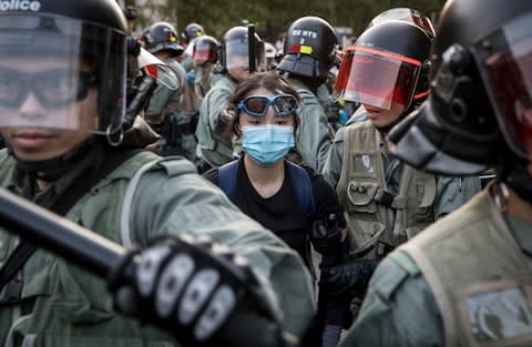 A pro-democracy protester is arrested by police at a gathering in a shopping mall in Hong Kong, China - Credit: Chris McGrath&nbsp;/Getty