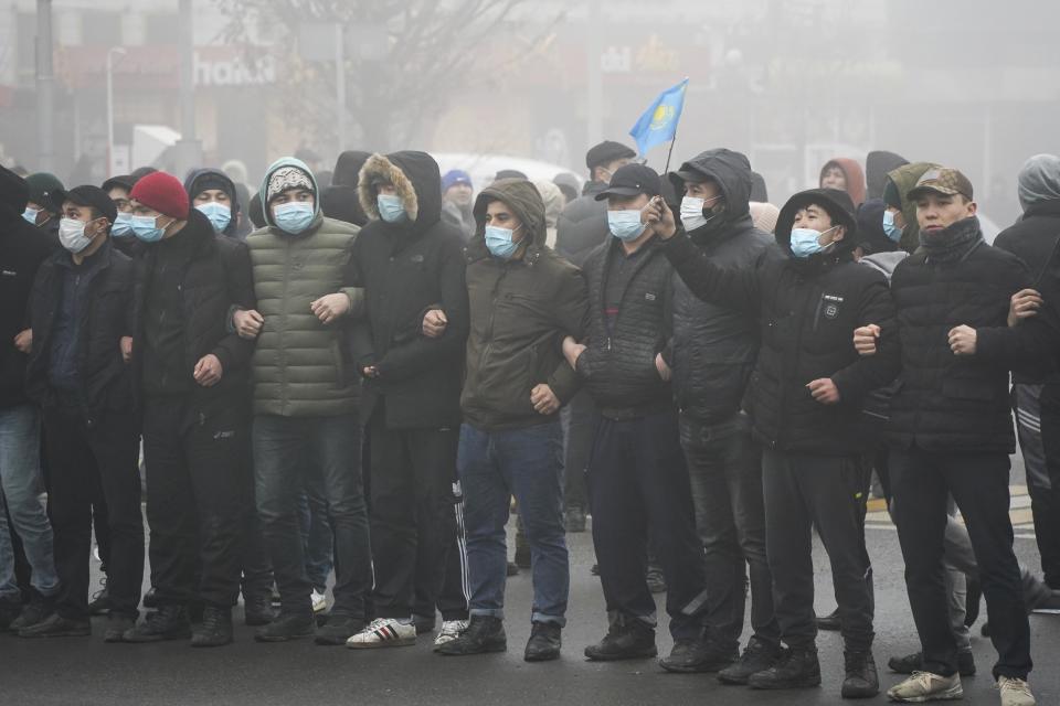 FILE - Demonstrators stand in front of police line during a protest in Almaty, Kazakhstan, Wednesday, Jan. 5, 2022. Demonstrators denouncing the doubling of prices for liquefied gas have clashed with police in Kazakhstan's largest city and held protests in about a dozen other cities in the country. (Vladimir Tretyakov/NUR.KZ via AP, File)