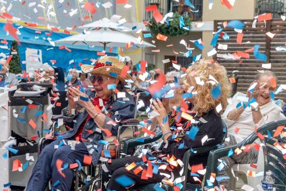 From left, Dolores "Bootsie" Kawa and her daughter Linda Frazee are covered in confetti at Independence Village of Brighton Valley after Kawa won first place in the 2023 Ageless Talent Show put on by StoryPoint Group senior living communities