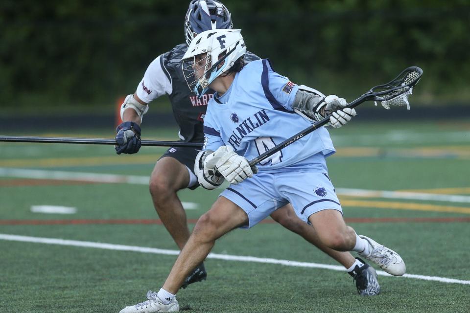 Franklin’s Jayden Consigli looks for an open teammate during the Division 1 Round of 8 contest against Lincoln-Sudbury at Lincoln-Sudbury Regional High School in Sudbury on June 14, 2022.