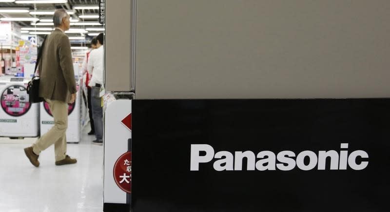 A man walks near a logo of Panasonic Corp at an electronics store in Tokyo April 28, 2014. REUTERS/Toru Hanai