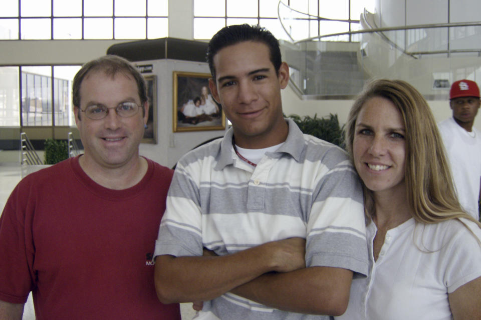 In this photo provided by TeriAnn Reynolds, John and TeriAnn Reynolds, of Johnson City, Tenn., flank minor league baseball player Eduardo Sanchez, of Venezuela, after the end of the minor league baseball season, at the airport in Blountville, Tenn., in August 2007. TeriAnn Reynolds and her family were part of a little-known but vital piece of baseball's minor leagues for decades: host families. (Photo courtesy TeriAnn Reynolds via AP)