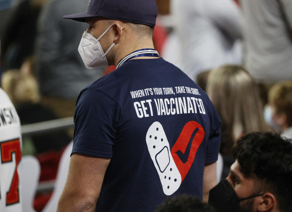 A fan wearing a protective face mask and shirt relating to the vaccine for the coronavirus during the game in Tampa February 7, 2021 REUTERS/Brian Snyder