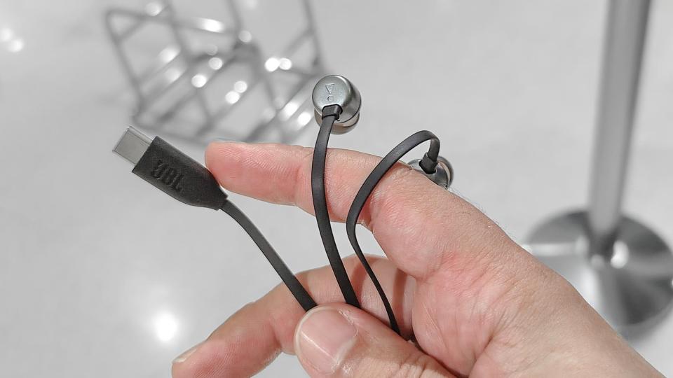 JBL's Tune 310C USB-C headphones in hand before boarding a flight