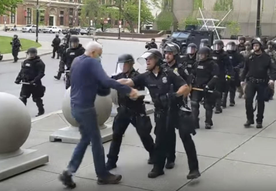 FILE - This June 4, 2020, file image from video provided by WBFO, a Buffalo police officer appears to shove a man who walked up to police in Buffalo, N.Y. (Mike Desmond/WBFO via AP)
