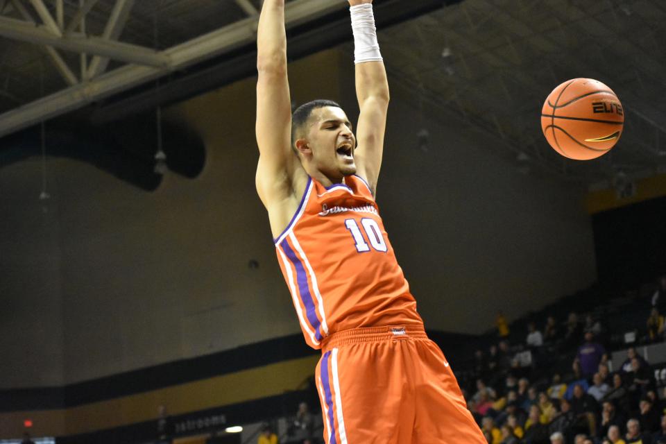 Yacine Toumi celebrates after a first-half dunk during the Purple Aces' showdown with Murray State on Saturday.