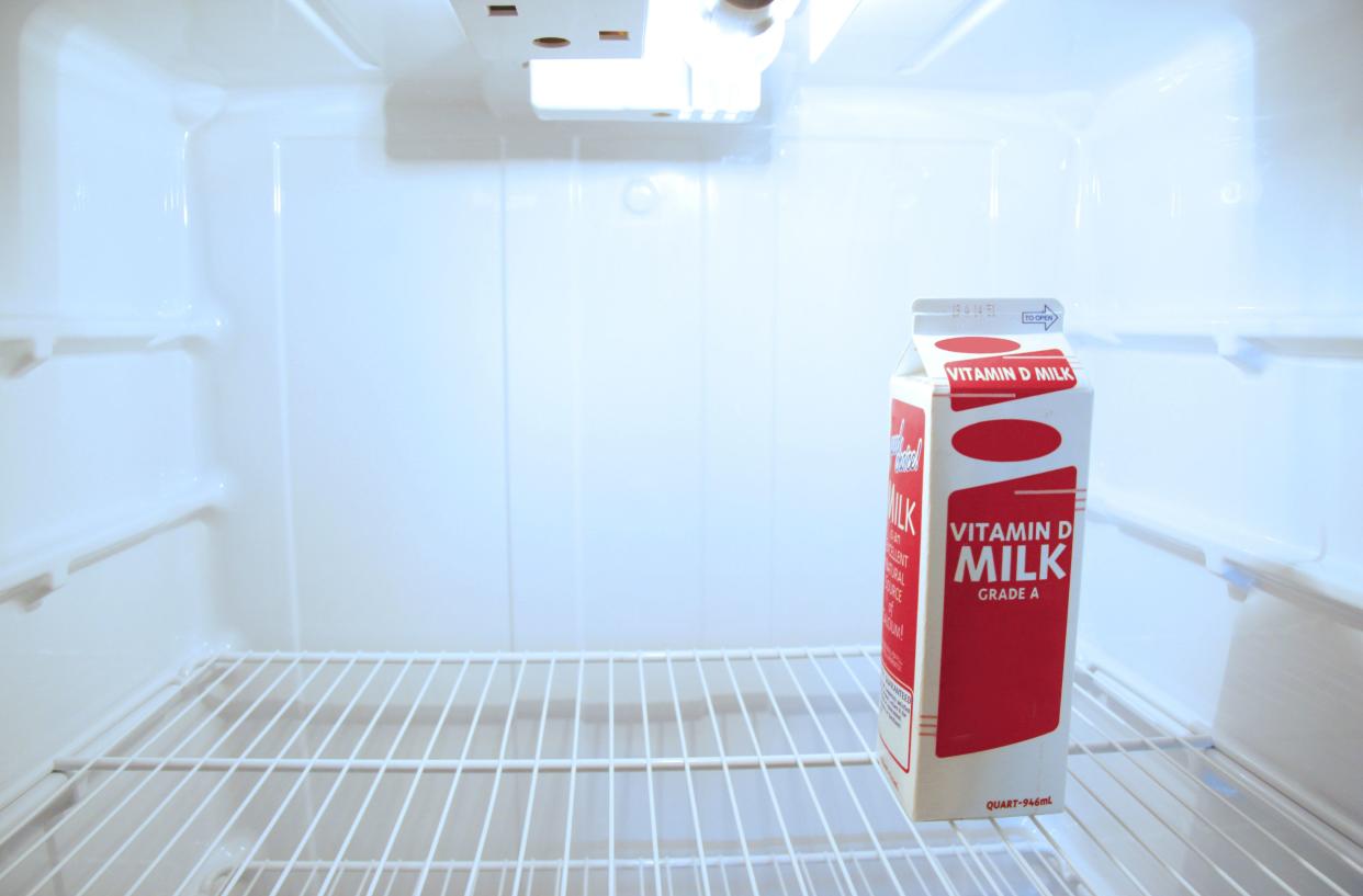 Quart of milk in an empty fridge.