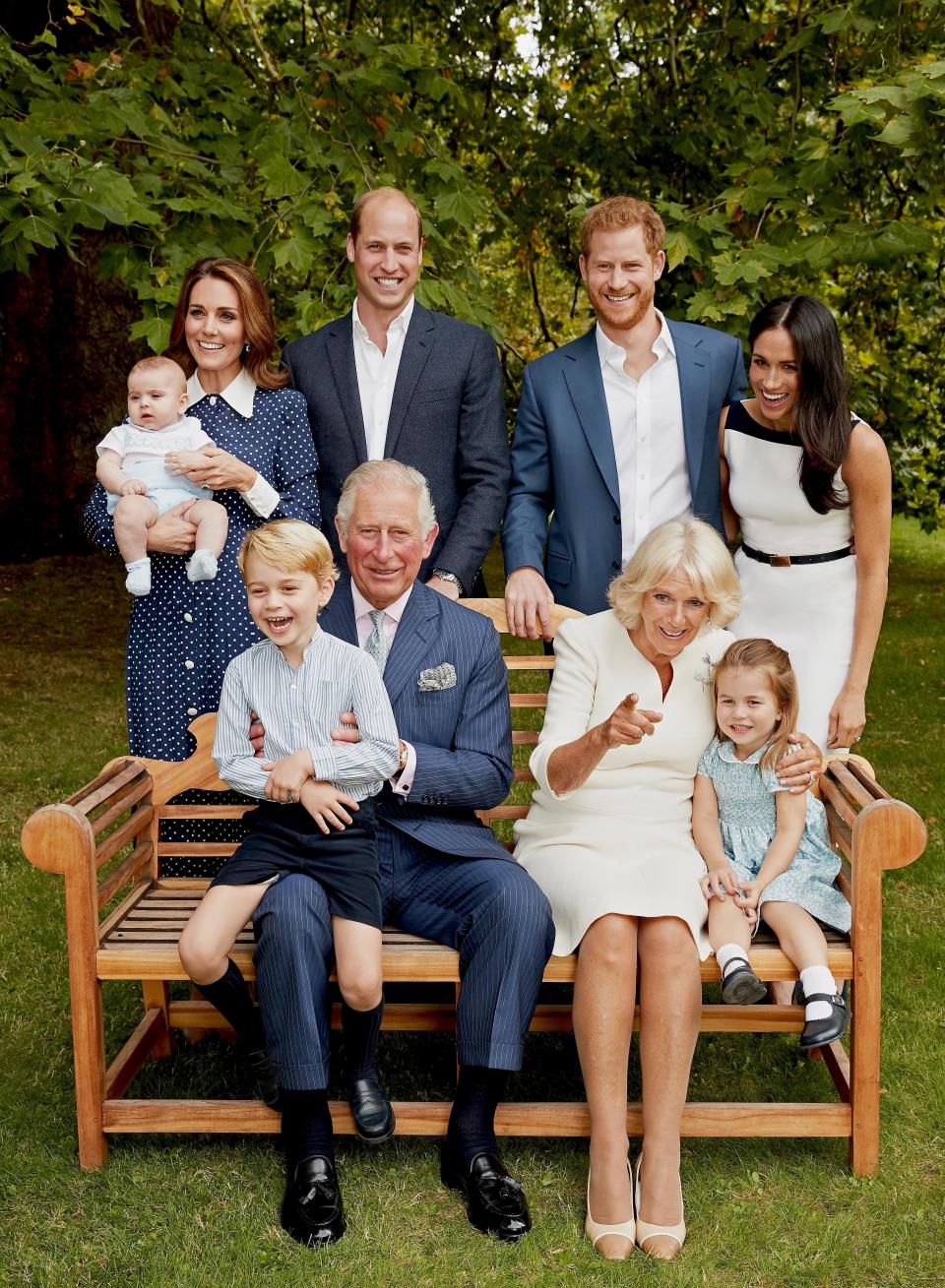 A royal family portrait featuring Prince Charles, Camilla, Prince William, Kate Middleton, their children, and Prince Harry and Meghan Markle