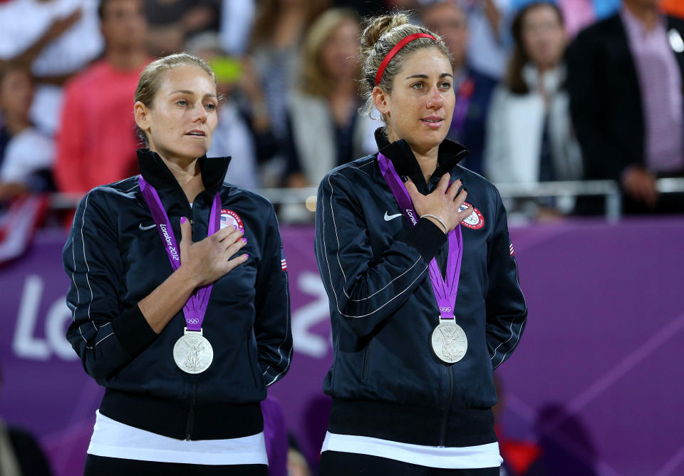 LONDON, ENGLAND - AUGUST 08: Silver medallists Jennifer Kessy (L) and April Ross of the United States celebrate on the podium during the medal ceremony for the Women's Beach Volleyball on Day 12 of the London 2012 Olympic Games at the Horse Guard's Parade on August 8, 2012 in London, England. (Photo by Cameron Spencer/Getty Images)