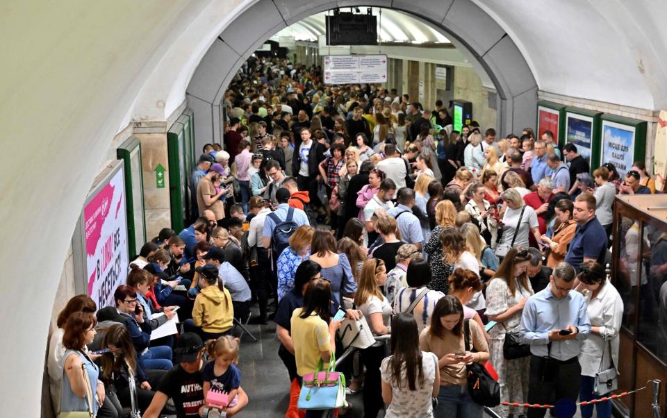 Local residents take shelter in a metro station in the centre of Kyiv during a Russian missile strike - SERGEI SUPINSKY/AFP