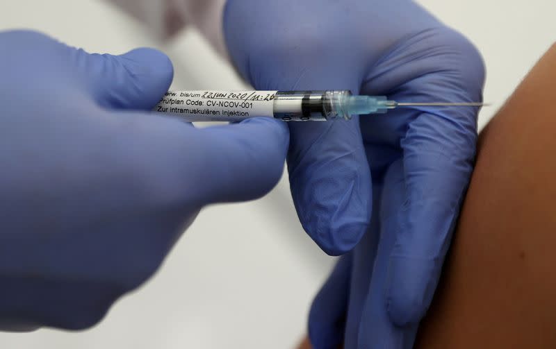 FILE PHOTO: FILE PHOTO: CureVac's experimental COVID-19 vaccine is given to a volunteer in clinical trials