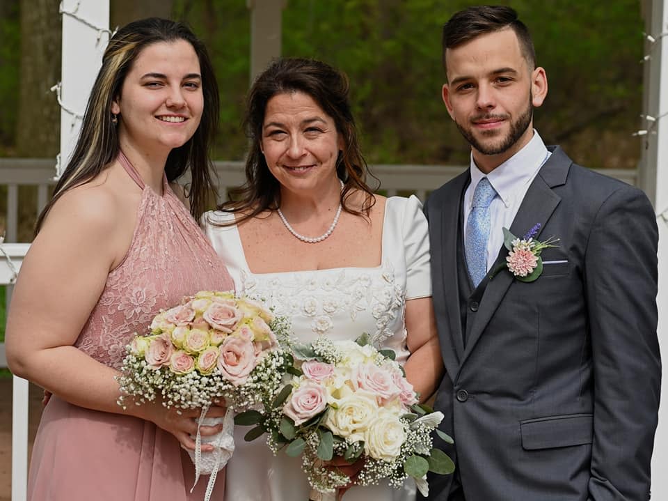 Susan Ousterman, center, poses with her children on her wedding day in 2019.