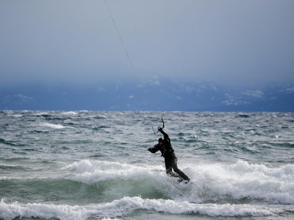 A kite boarder surfing on Lake Tahoe amid large waves